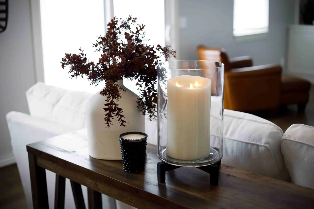 Farmhouse console styling with candle and greenery
