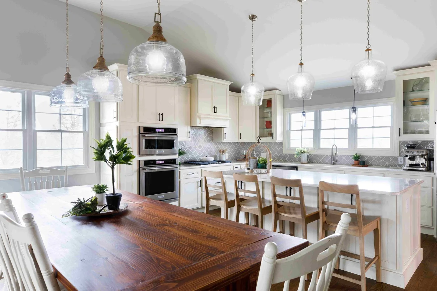 Luxury Farmhouse kitchen and dining area with vaulted ceiling and pendant lighting