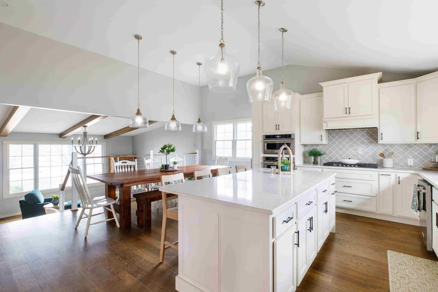 Farmhouse kitchen with white cabinetry and vaulted ceiling